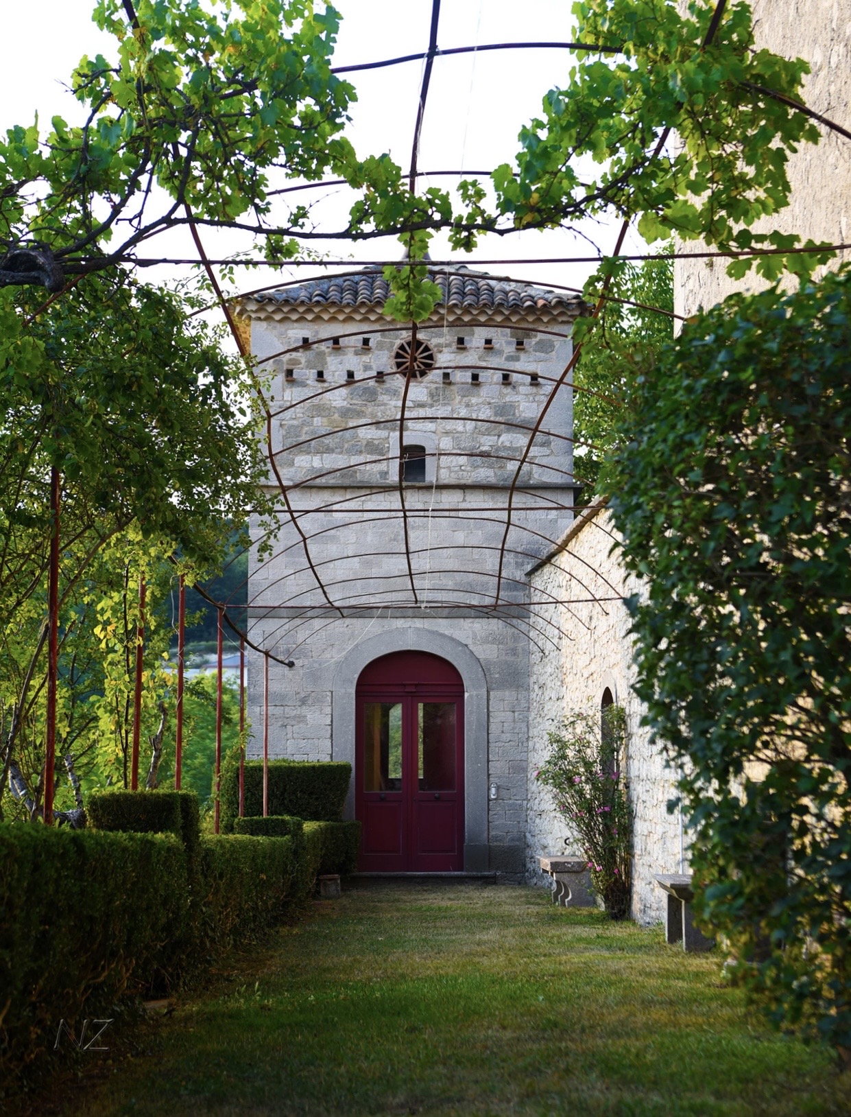 Stone tower and vine-covered garden walkway at Palazzo Galanti